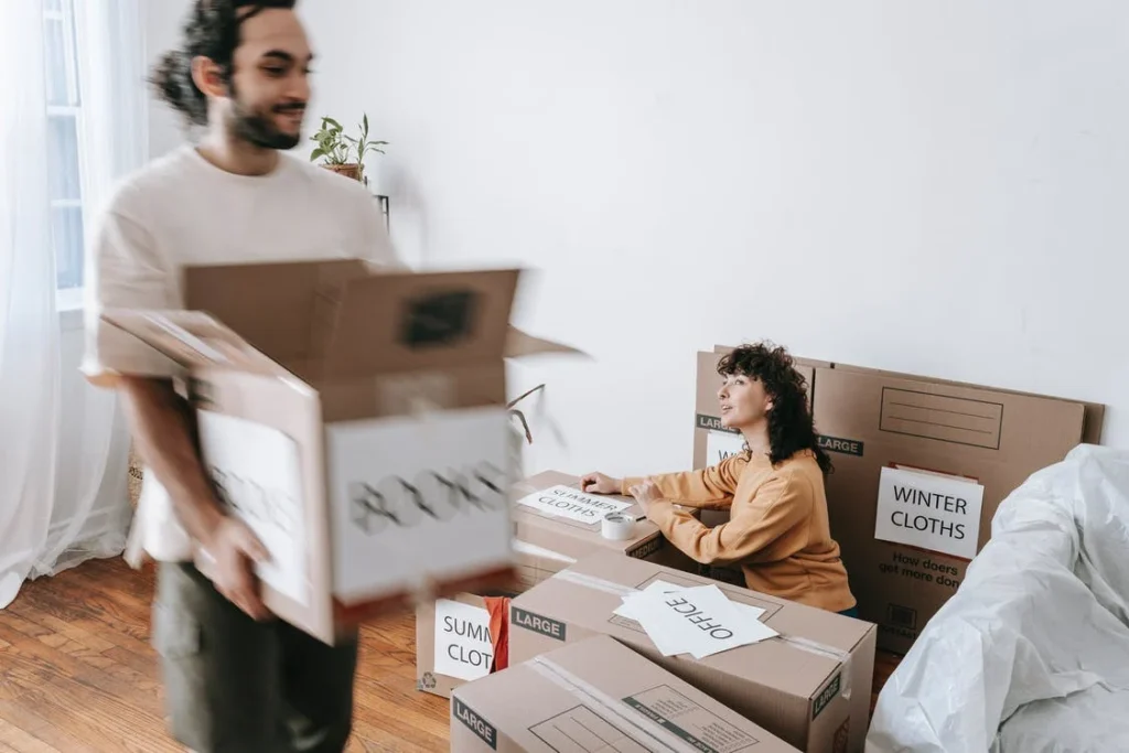 Couple packing items in boxes